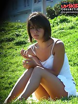 24 pictures - Hidden cam upskirt. Beatiful brunette in white caught