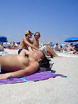 24 pictures - A busty bikini slut undressing on the Hanauma